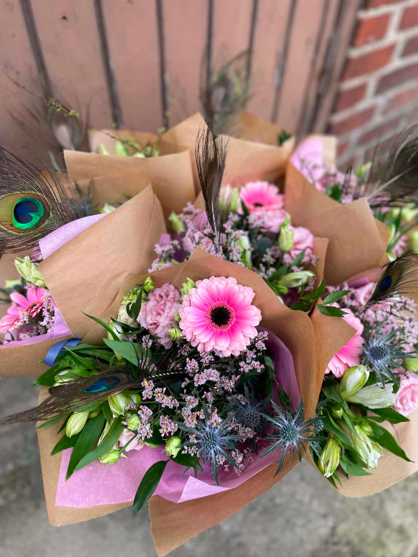 Rosa buketter med påfågelsfjädrar
